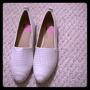 One pair of white flat sneaker like shoes